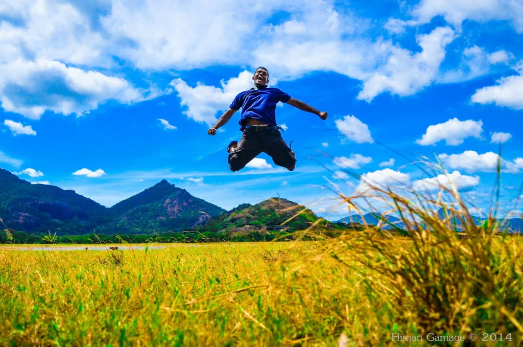 Nipuna Shanthidewa jumping by a lake in Sri Lanka